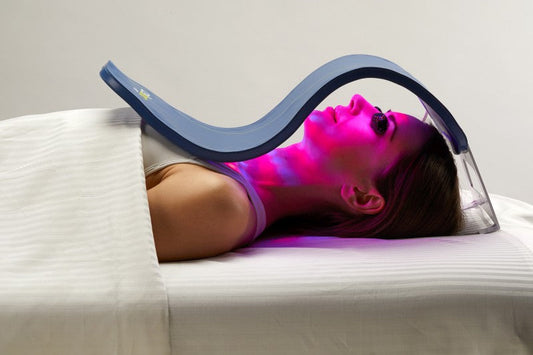 Woman using a LED light therapy for acne and aging